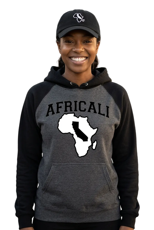 Individual portrait of a smiling Black American woman wearing the Africali hoodie and embroidered dad hat