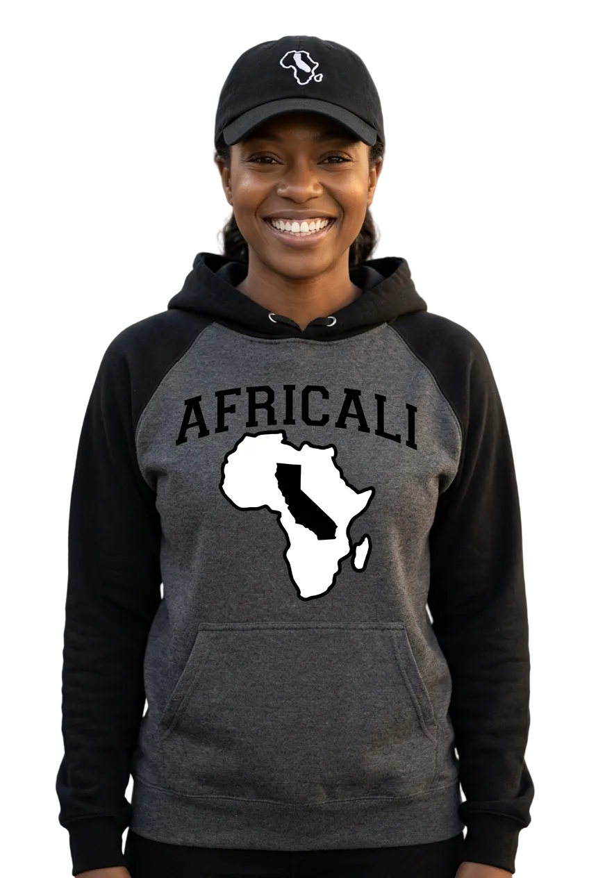 Individual portrait of a smiling Black American woman wearing the Africali hoodie and embroidered dad hat